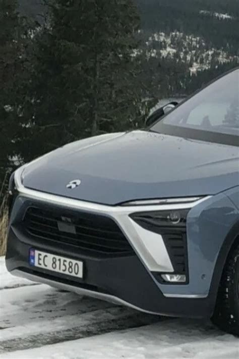 An Electric Car Is Parked In The Snow