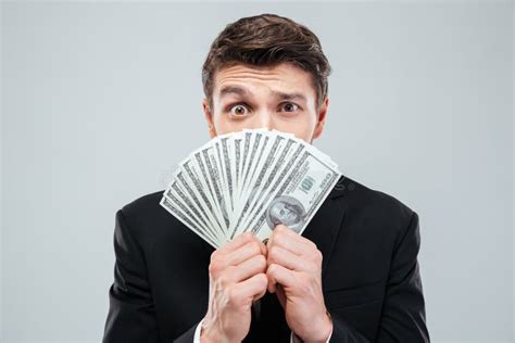 Confused Young Businessman Covered His Face With Money Stock Image