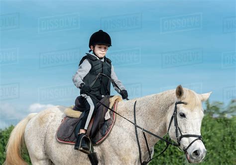 Boy Horseback Riding At Ranch Stock Photo Dissolve