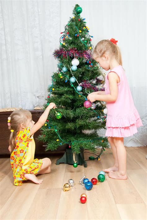 Christmas eve comes soon, hooray! Children Decorate The Christmas Tree Stock Photo - Image ...