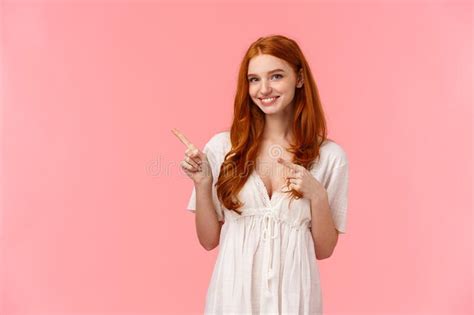 Waist Up Portrait Lovely European Redhead Female In White Fashionable Dress Pointing Finger