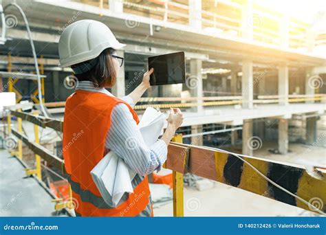 portrait of adult female builder engineer architect inspector manager at construction site