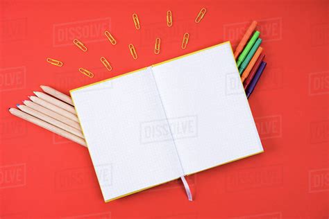 Flat Lay With Opened Blank Notebook With Paper Clips Color Pencils And