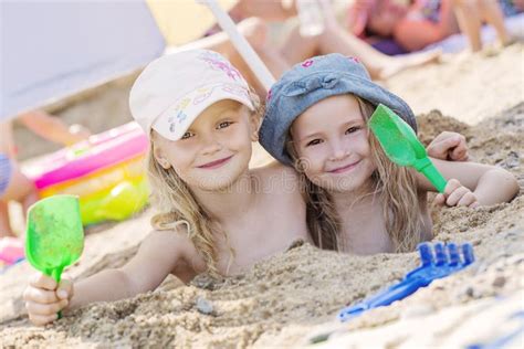 Two Little Girls Playing In The Sand Stock Image Image Of Beautiful