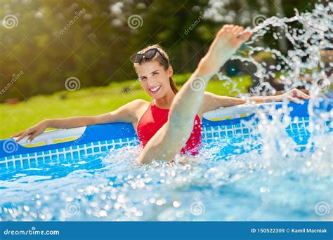Close Up View Of Attractive Woman Relaxing On Swimming Pool In The