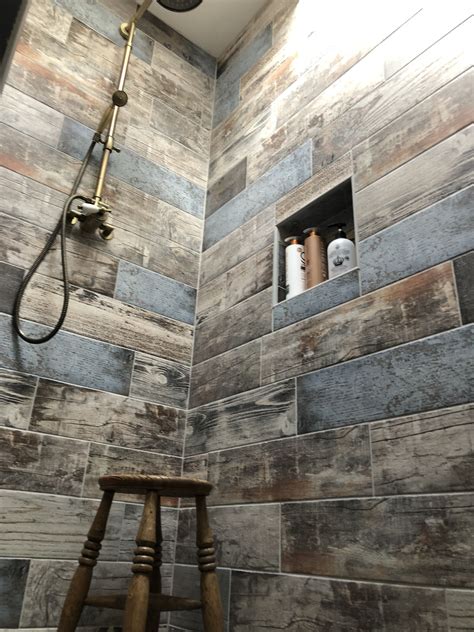 Choosing bathroom tiles for your home is a big decision. Wood effect tiles and antique brass fittings for a rustic ...
