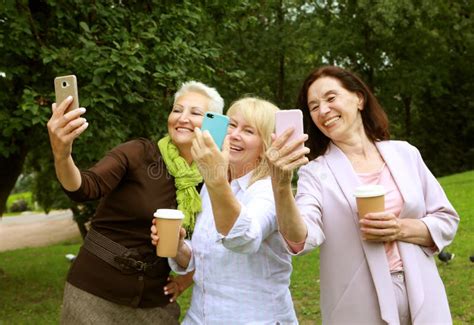 Women Taking Selfie In Summer Park Three Senior Ladies Laughing