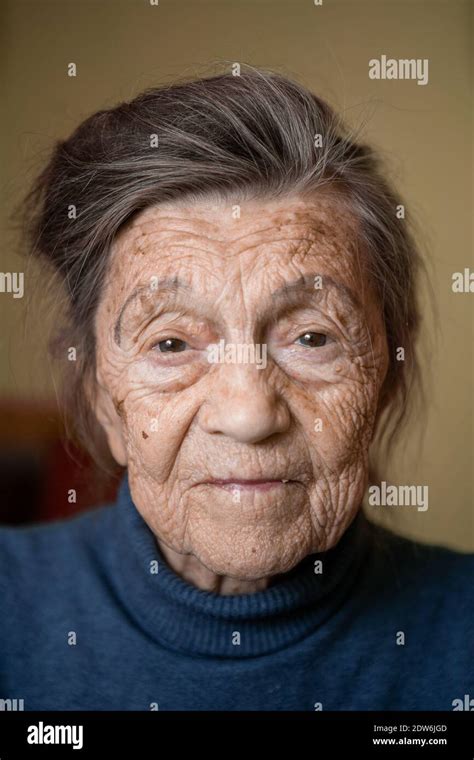 90 year old cute elderly woman with gray hair and wrinkles face wearing sweater portrait large