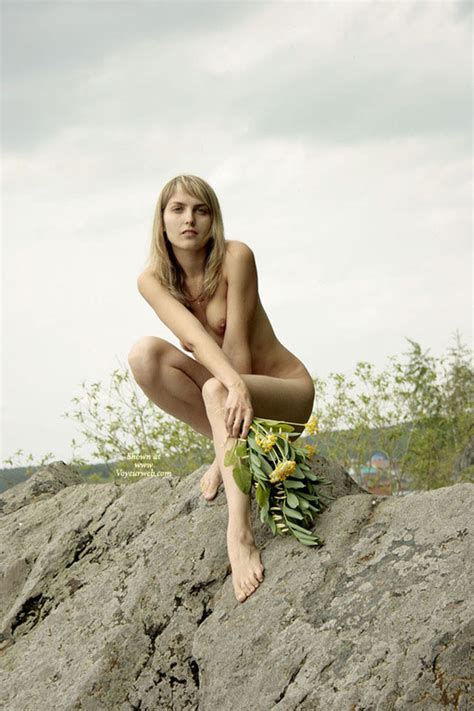Long Legged Nude Blond Girl Squatting On A Rock July
