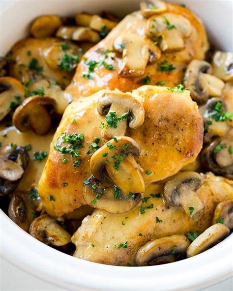 Chicken With Mushrooms And Parsley In A White Bowl
