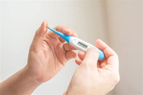 Hands Holding A Digital Thermometer Stock Image Image Of Isolated