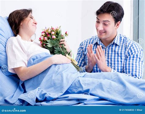 Caring Loving Husband Visiting Pregnant Wife In Hospital Stock Photo