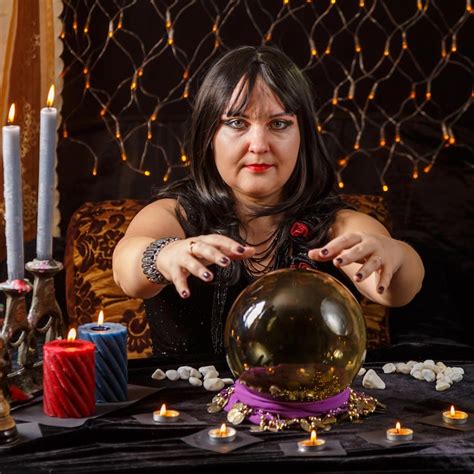 Premium Photo Fortune Teller Woman Brunette In A Magic Salon Reads The Future In A Crystal Ball