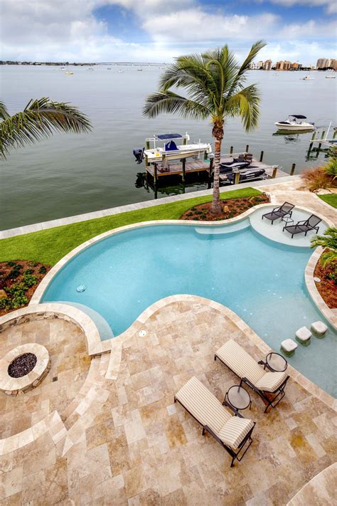 Bay Front Home Backyard Swimming Pool With Marble Tile Patio And