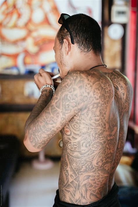 Thai Tattoo Artist Smoking A Cigarette During A Break By Stocksy Contributor Mauro Grigollo