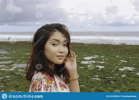 A Young Asian Girl On The Beach Is Smiling At The Camera At Gunungkidul