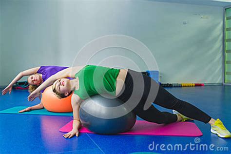 Two Young Sporty Women Doing Gymnastic Exercises Or Exercising In