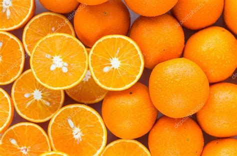 A Closeup Of A Pile Of Oranges Sliced And Whole — Stock Photo © La