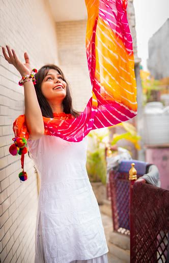 Beautiful Indian Girl In Traditional Indian Dress Throwing Colorful