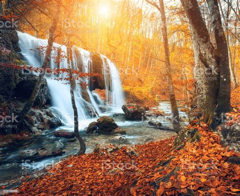 Waterfall At Mountain River In Autumn Forest At Sunset Stock Photo