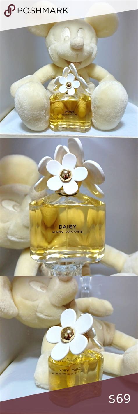 DAISY By MARC JACOBS PERFUME IN A BEAUTIFUL CONTAINER WITH 3 DAISYS