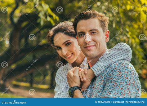 Portrait Smiling Young Man And Woman Couple In Love Hugging In The Park
