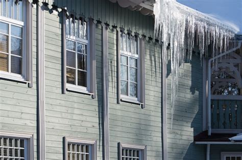 Premium Photo Icicles Hanging From The Roof Of A Wooden Building In