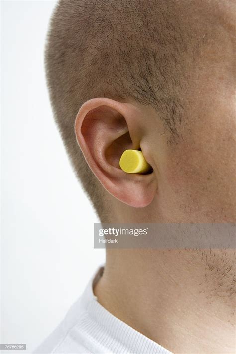 Detail Of A Man Wearing Ear Plugs High Res Stock Photo Getty Images