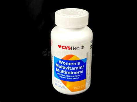 a bottle of cvshealth women`s multivitamin multimineral supplement editorial photography image