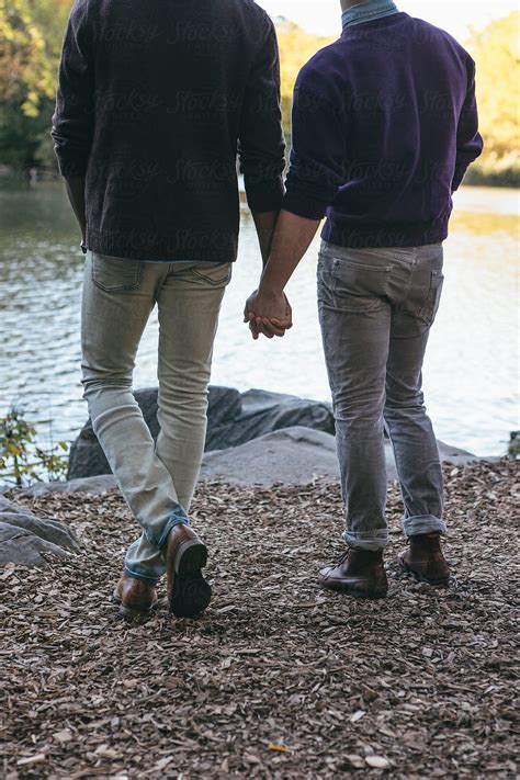 Young Gay Men Couple Holding Hands Together Enjoying Romantic Central Park In Autumn In New