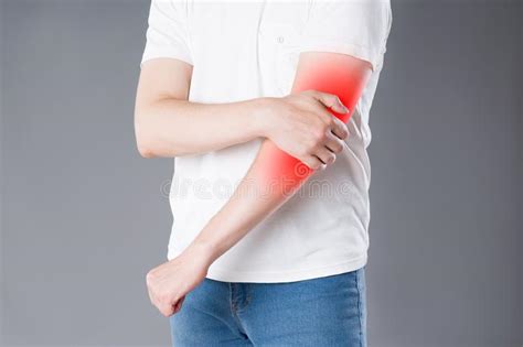 Man Suffering From Pain In Elbow Joint Inflammation Stock Photo