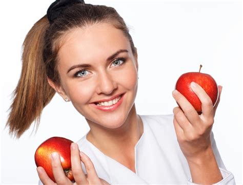 Premium Photo Young Happy Girl Is Holding Red Apple Isolated Over White