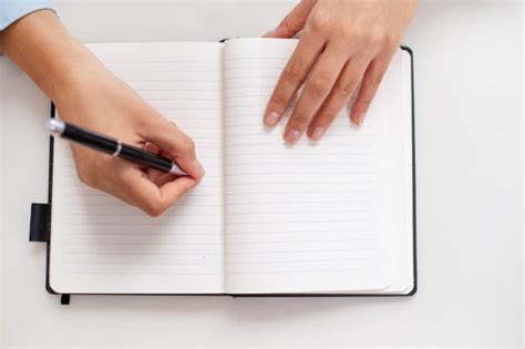 Free Photo Top View Of Female Hands Writing In Notebook On Desk