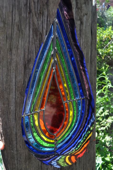 A Multicolored Stained Glass Hanging From A Tree