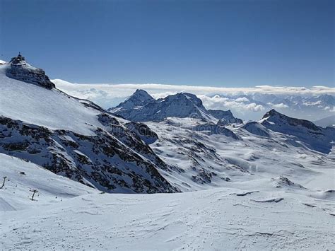 Beautiful Panoramic View Of Snow Capped Mountains With Ski Slopes In