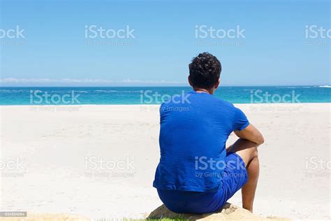 One Man Sitting Alone At The Beach Stock Photo Download Image Now