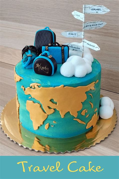 A Blue And Gold Cake With Luggage On Its Top Is Sitting On A Wooden Table