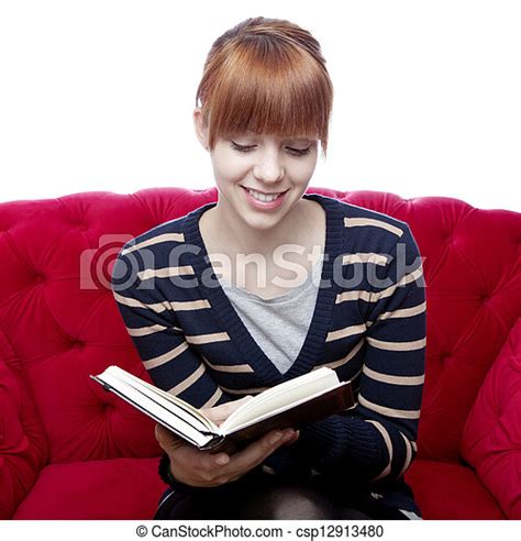 Young Beautiful Red Haired Woman On Red Sofa Read A Book In Front Of