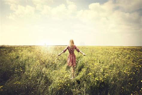 Dreamy Woman Walking In Nature Towards The Sun In A Surreal Place