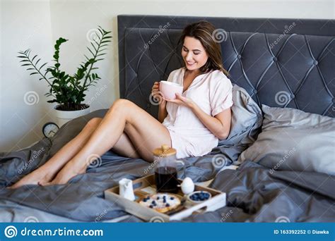 Breakfast In Bed Young Beautiful Woman In Pajamas Drinking Coffee In