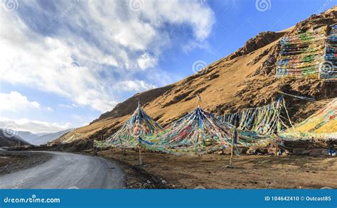 Tibetan Landscape In China With Prayer Flags On Foreground And A Road
