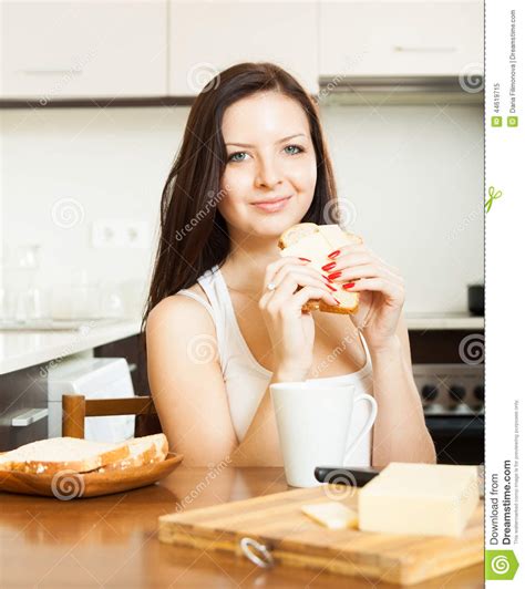 woman having breakfast at kitchen stock image image of female butter 44619715