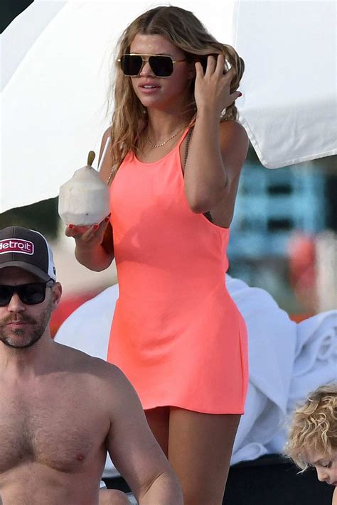 sofia richie wears a coral pink dress over her bikini while relaxing at the beach with scott