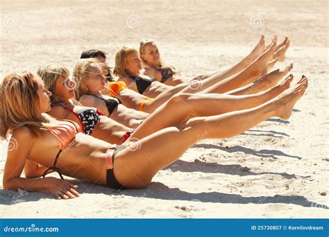 Several Girls In Bikini Lying On Sandy Beach Stock Image Image Of