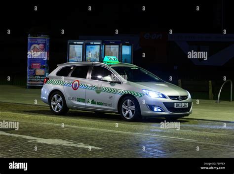 Taxi Cab At Night In Street In Uk Stock Photo Alamy