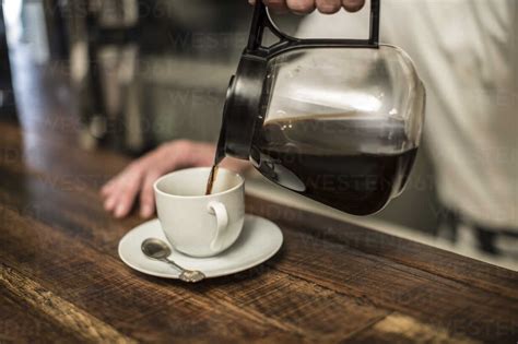 Pouring Coffee Into Cup Stock Photo