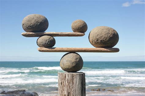 Rocks Balancing On Driftwood Sea In By Dimitri Otis