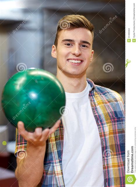 Happy Young Man Holding Ball In Bowling Club Stock Photo Image Of