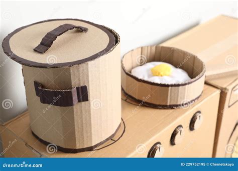 Cardboard Stove With Pot And Frying Pan Near White Wall Stock Image