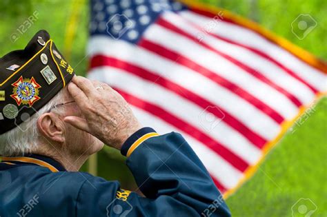 67859392 A Veteran Is Saluting In Front Of Us Flag Stock Photo Le Bus